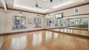A room with wooden floors and a ceiling fan.